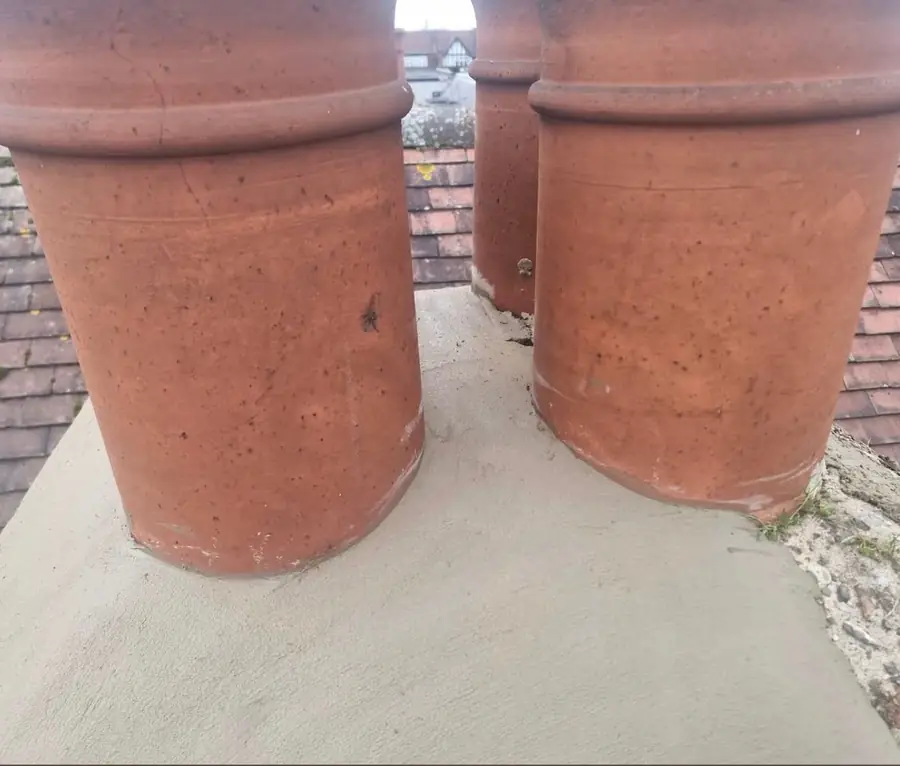 Three chimney pots re-set in new flaunching