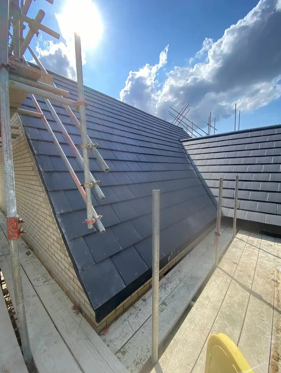 Dark grey slate-effect tiled roof finished in sunshine