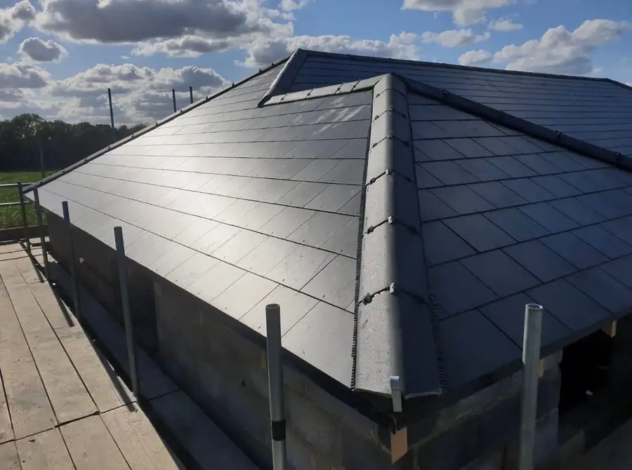Dark slate-effect hipped roof completed on a bungalow