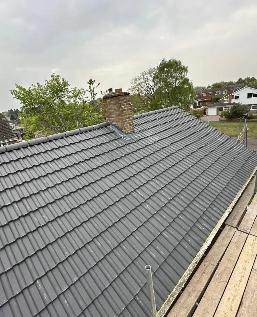 Grey slate-effect roof completed around a chimney