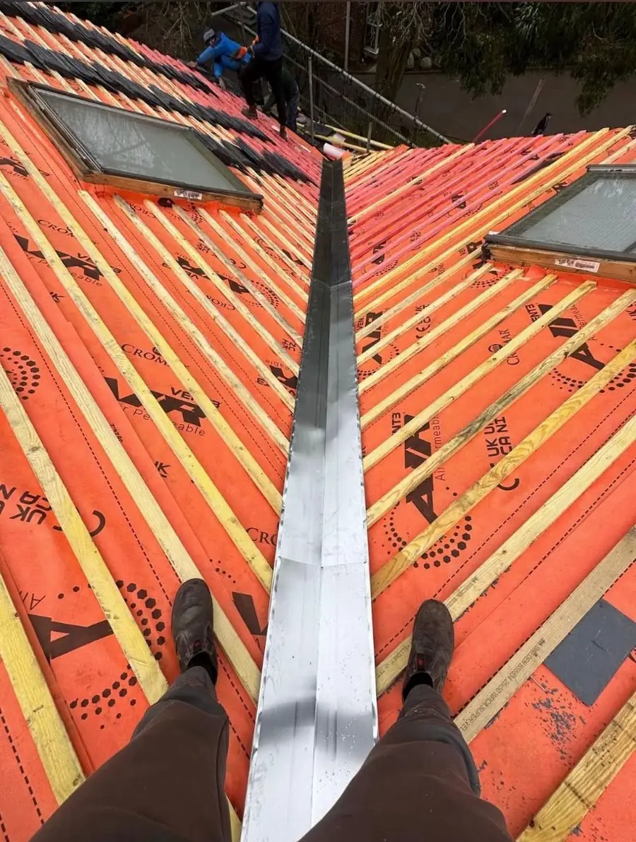 New lead valley laid over orange membrane before tiling