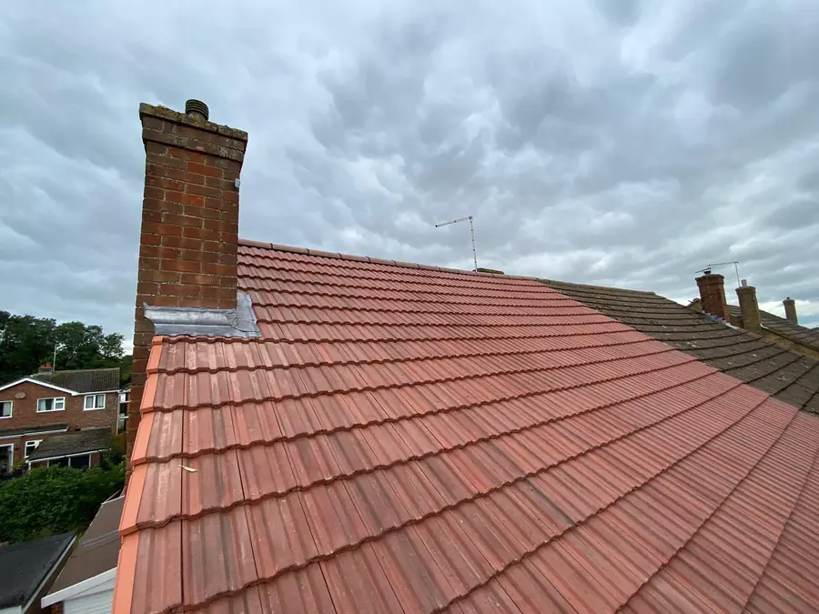 Red tiled roof and chimney stack after re-roofing