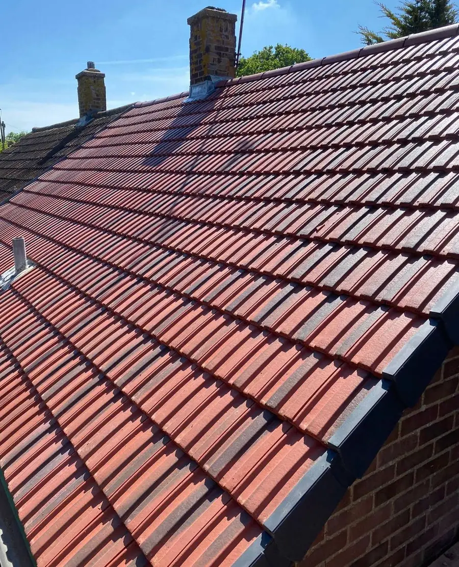 Finished red tiled roof with chimney and new ridge
