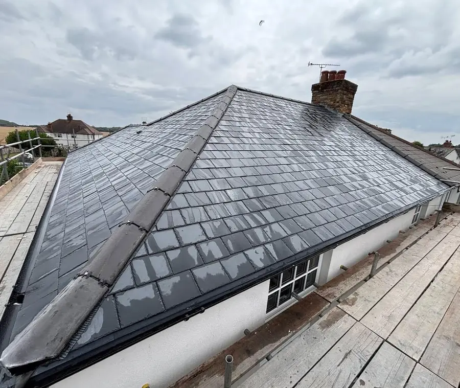 Natural slate roof completed on a bungalow with a chimney